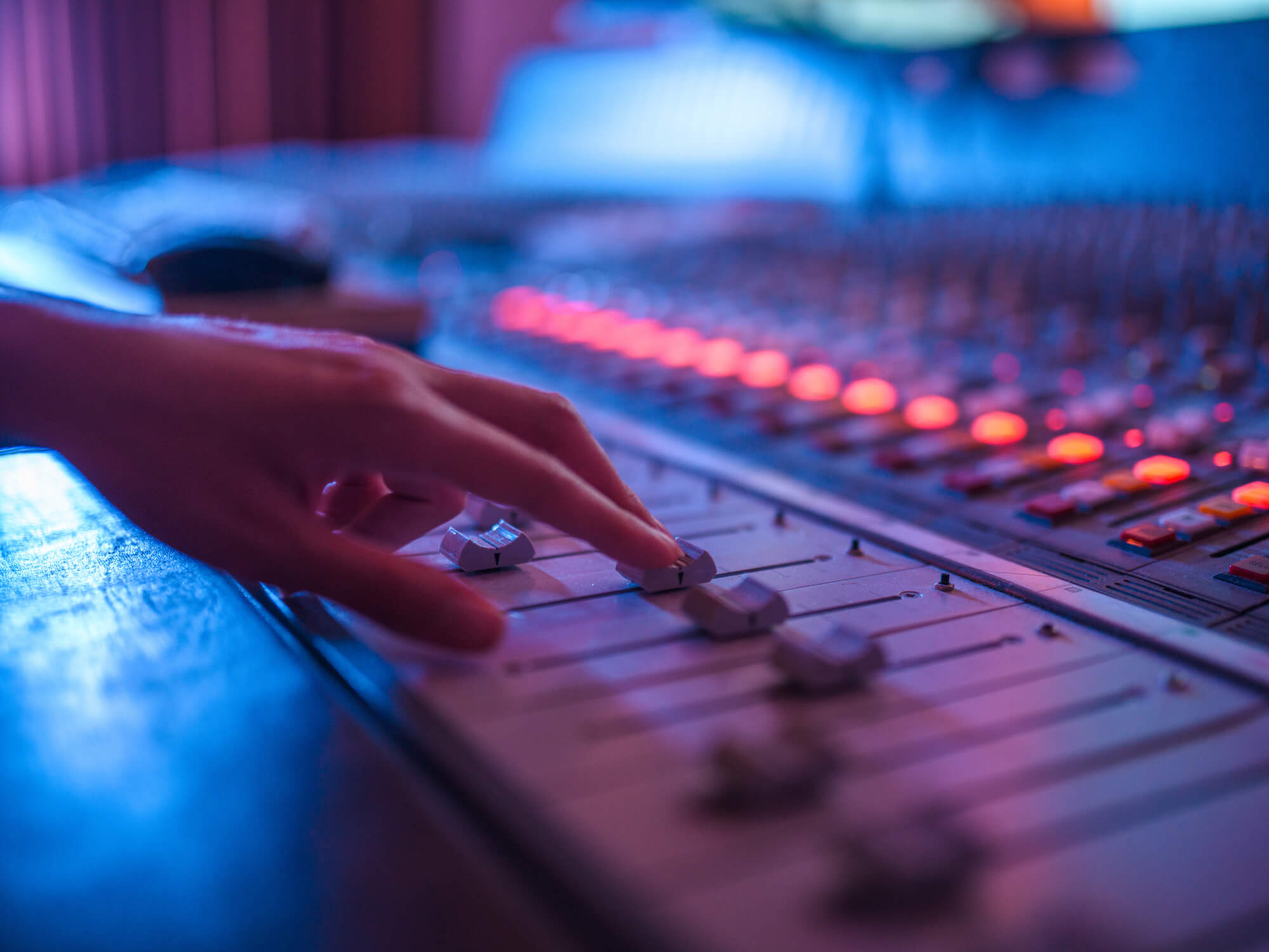Hand on a studio mixing desk