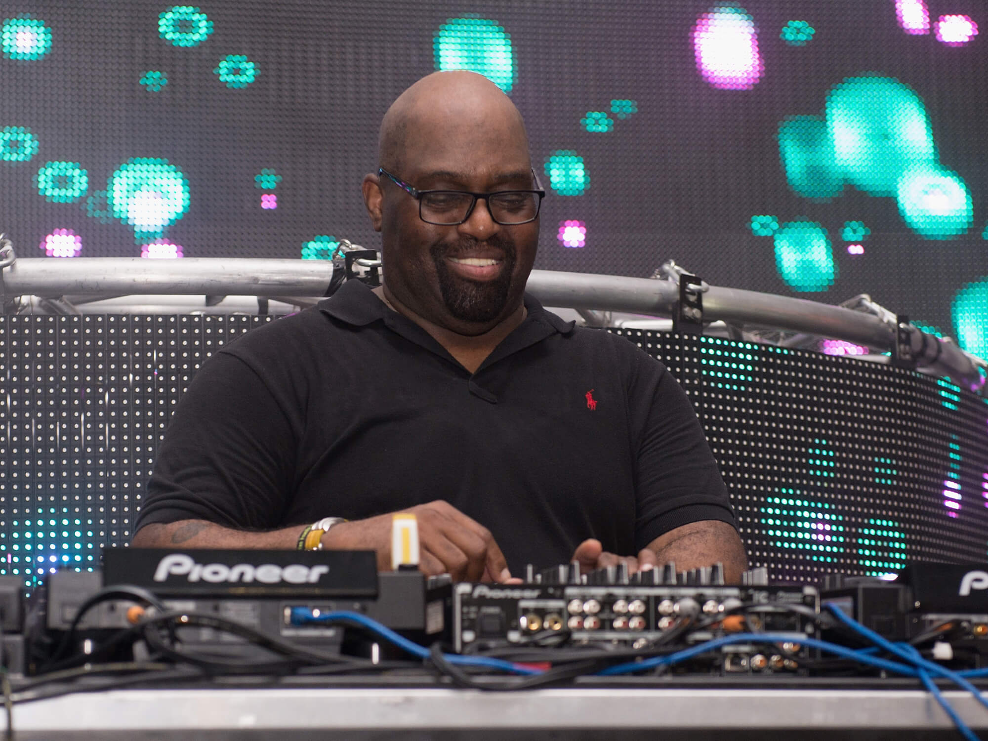 Frankie Knuckles smiling as he performs a set, captured in 2013