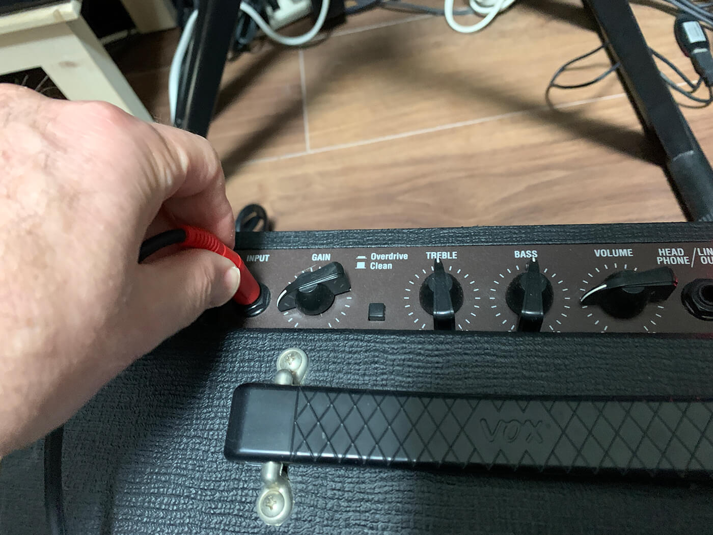 Use a regular audio cable and touch the other end with a finger to create hums, running it directly into an audio interface or a guitar amp for more gain