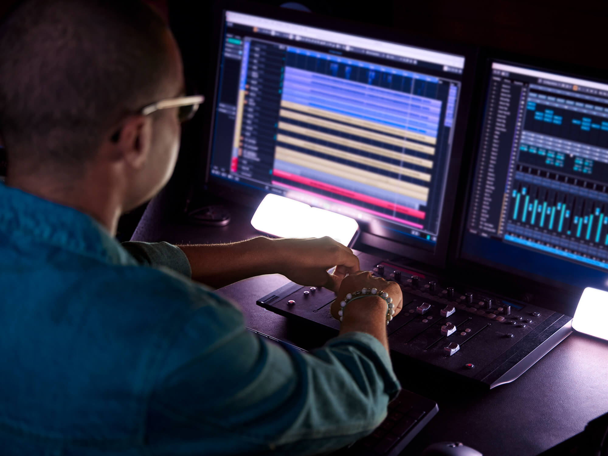 Producer working in music studio, photo by wundervisuals via Getty Images