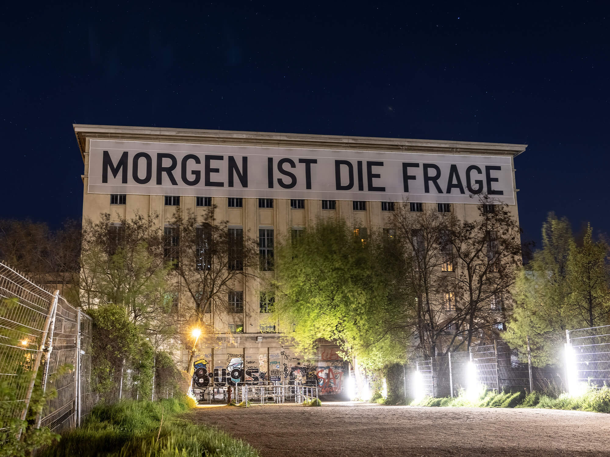 View from outside the Berghain venue. It's a tall, square building with "Morgen ist die frage" written on it in black letters.