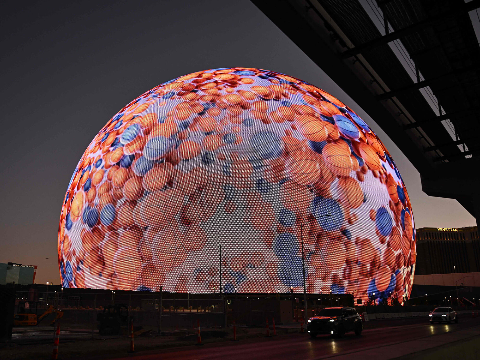 The Sphere illuminated with an image of lots of basketballs.