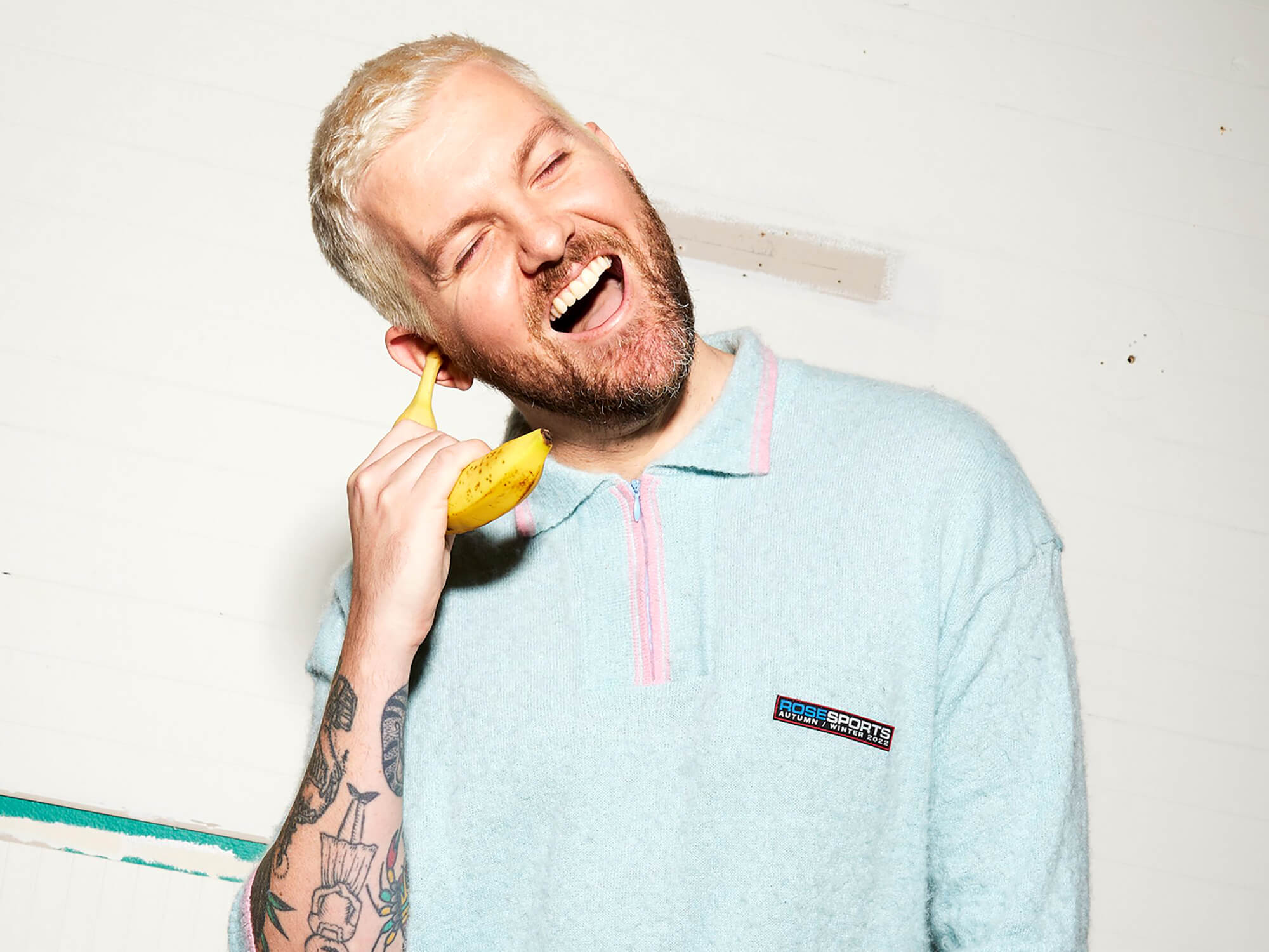 Dillon Francis holding a banana to his ear like a telephone, photo by Clare Gillen