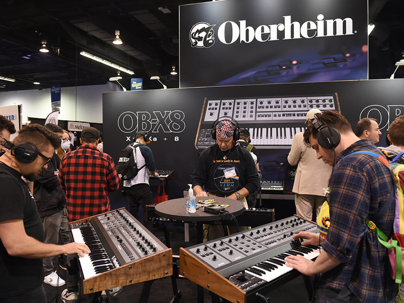 Attendees demo the OB-X8 synthesizer at the Oberheim booth during the NAMM show in 2022, photo by Chris Williams/Icon Sportswire via Getty Images