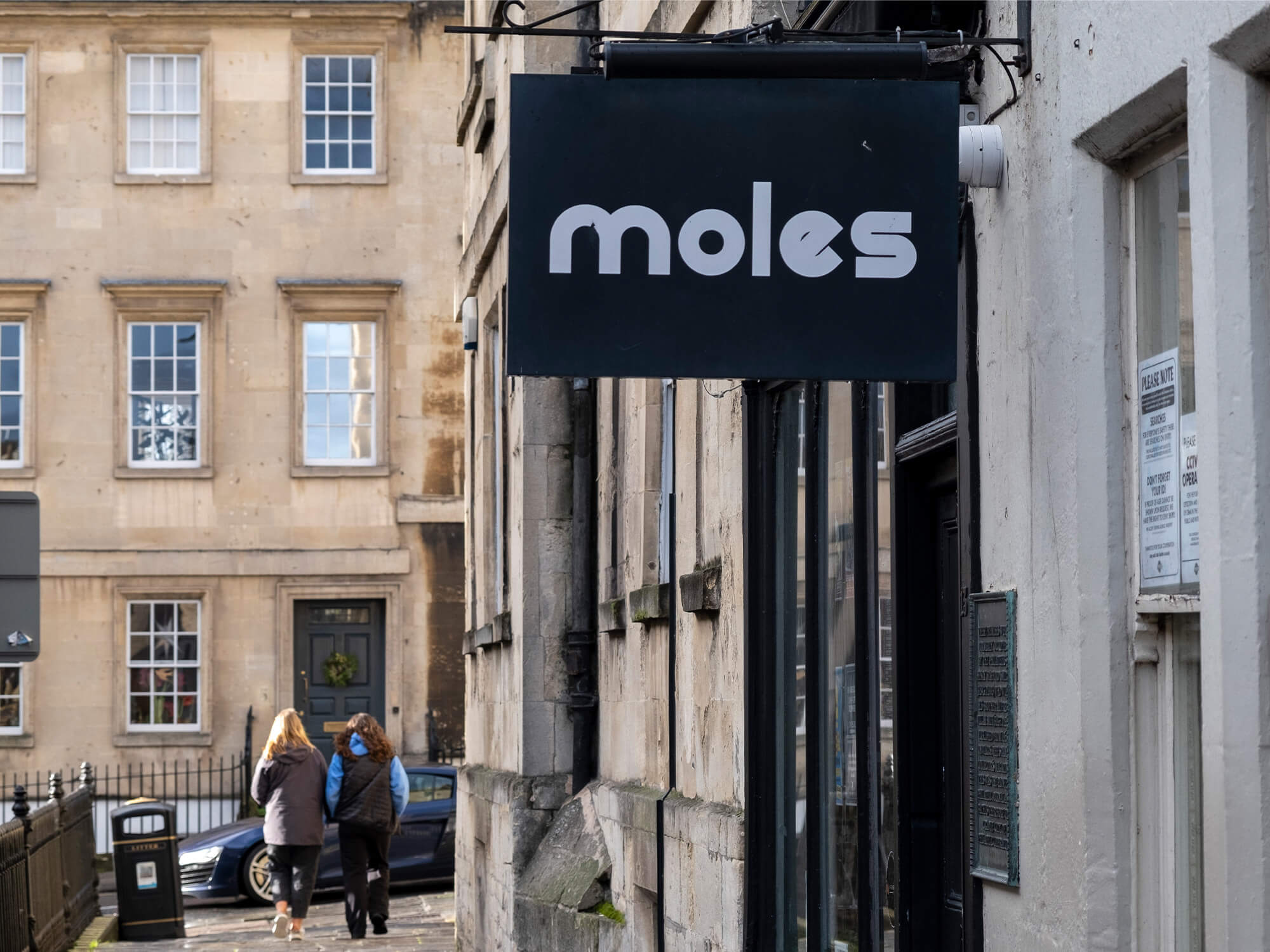 Moles in Bath. The photograph shows its black sign with the name Moles in white text outside the venue.