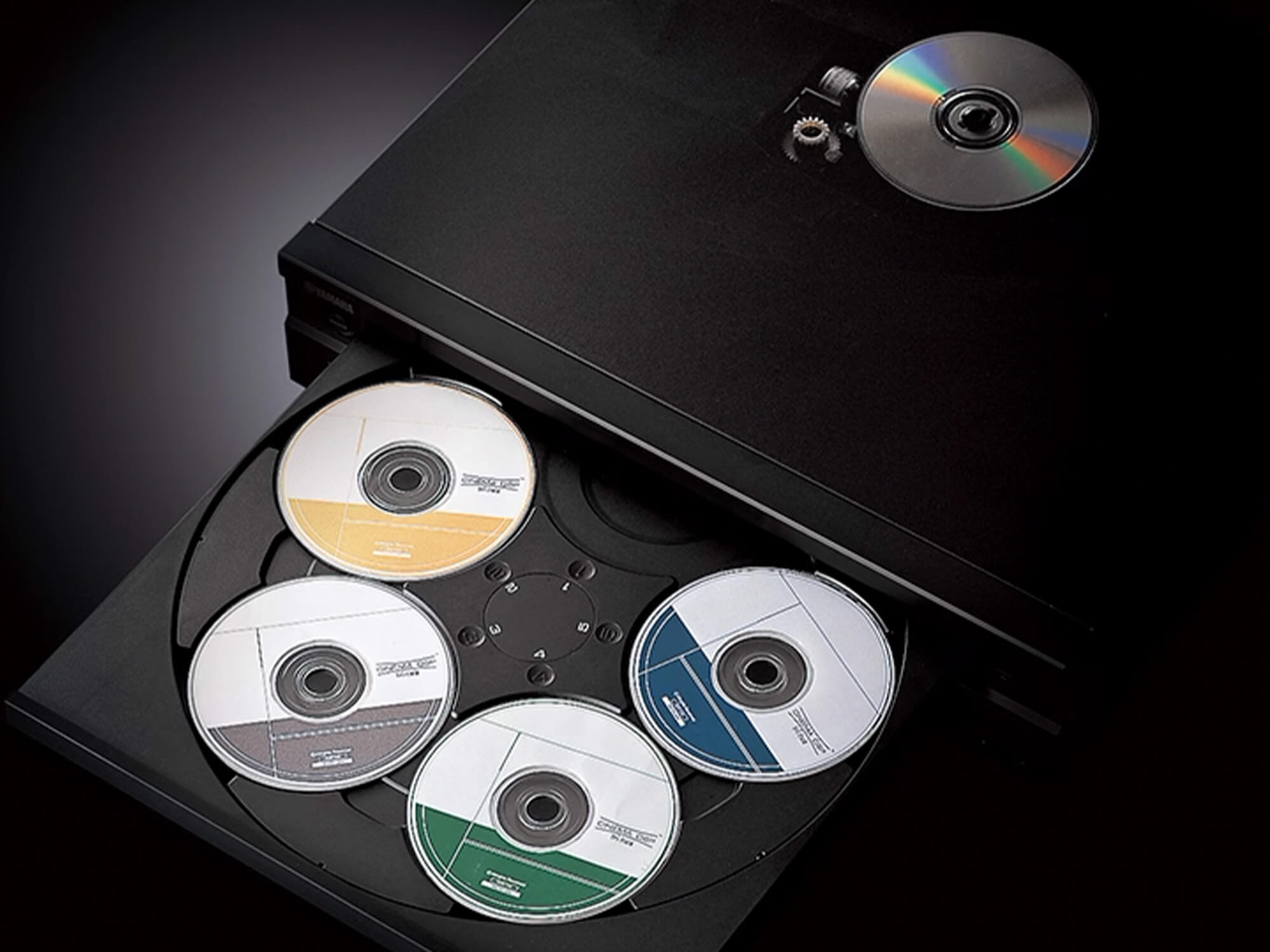 Yamaha CD-C603 player showing five discs in its large disc tray.
