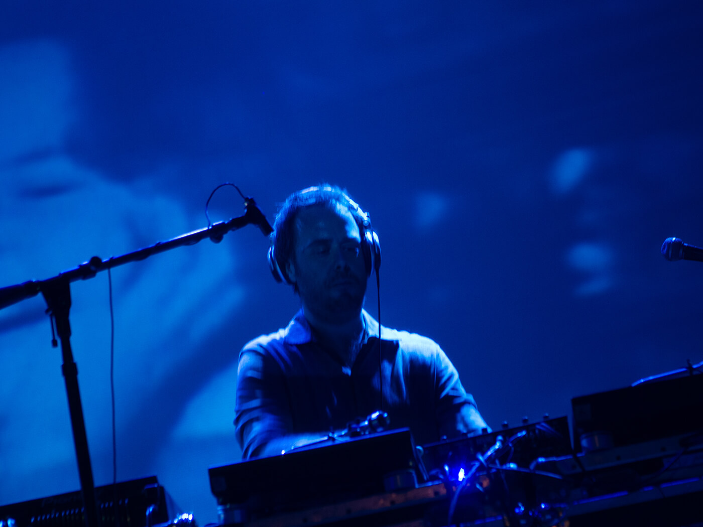 Cut Chemist performing with live visuals in the background, photo by Cut Chemist