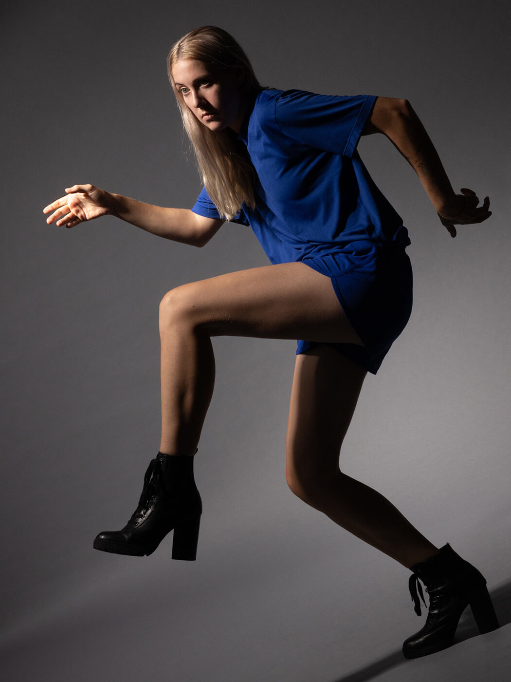 Torres in a blue outfit with her arms out, photo by Ebru Yildiz