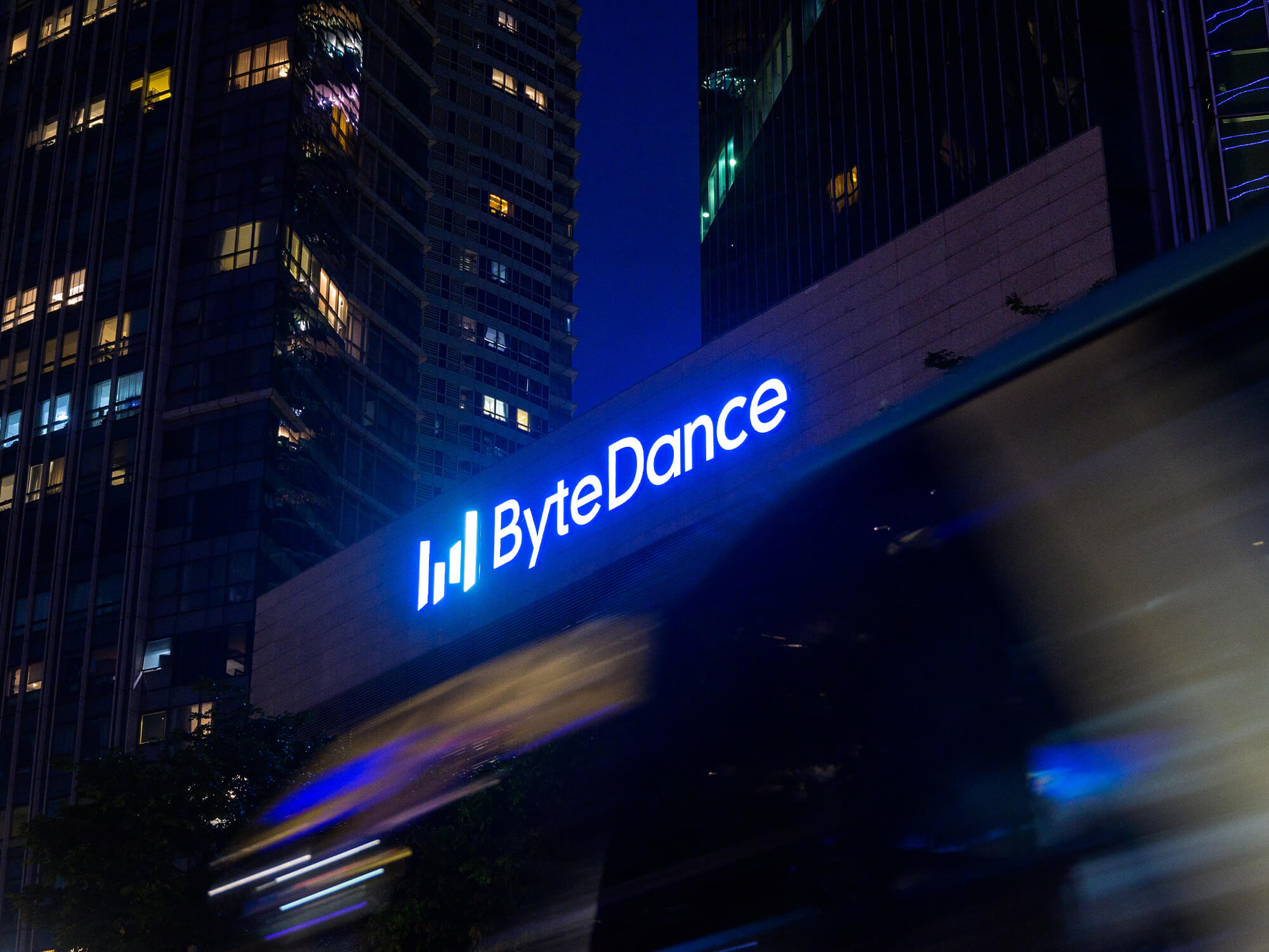 The ByteDance logo lit up in blue lights outside its headquarters in Singapore.