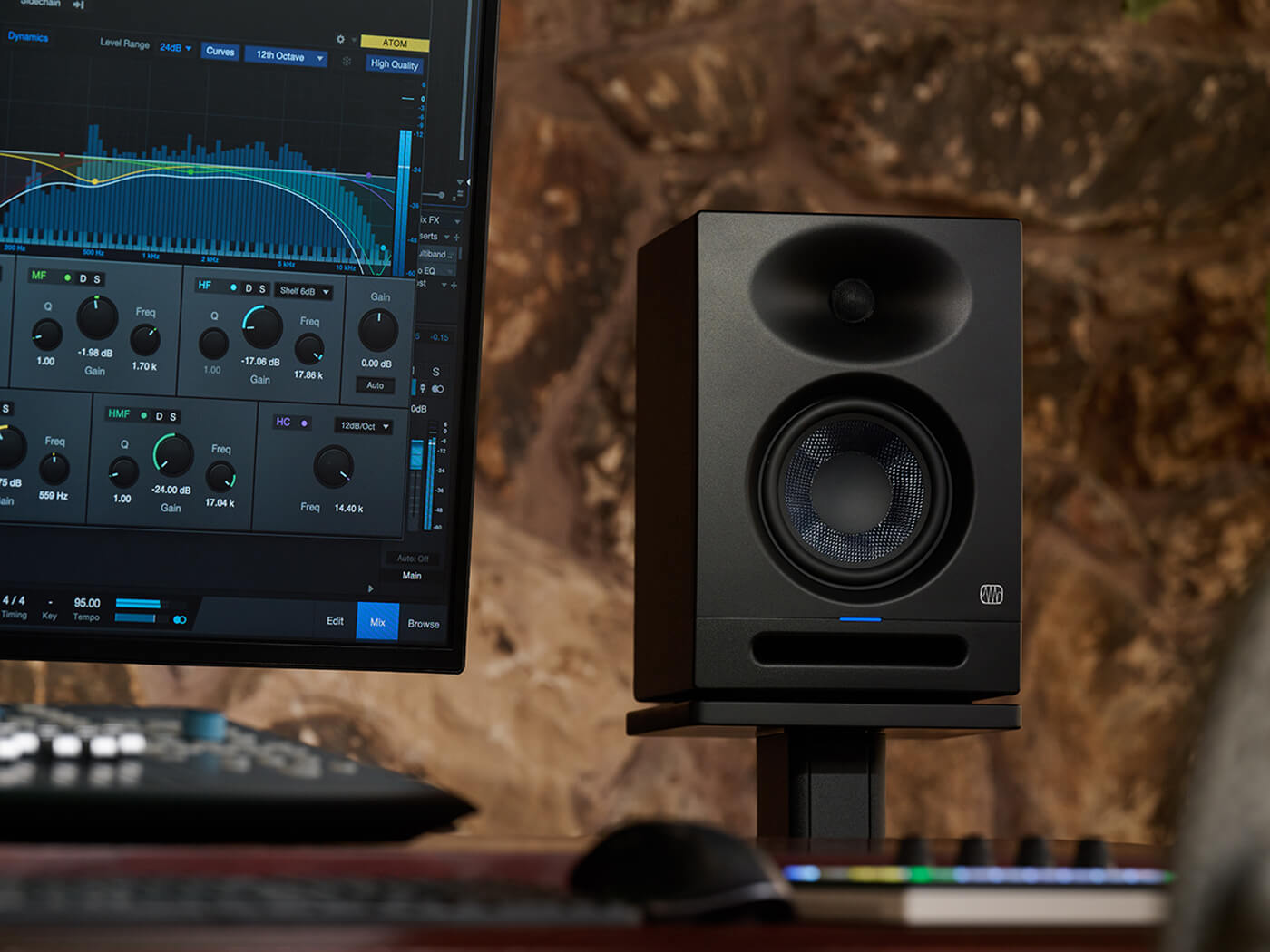 A PreSonus Eris Studio 5 monitor on a desk in a home studio