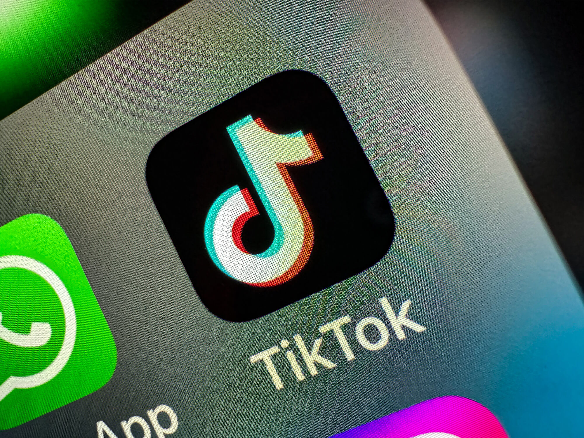 TikTok app icon on a phone screen. It shows a music note graphic on a black background.