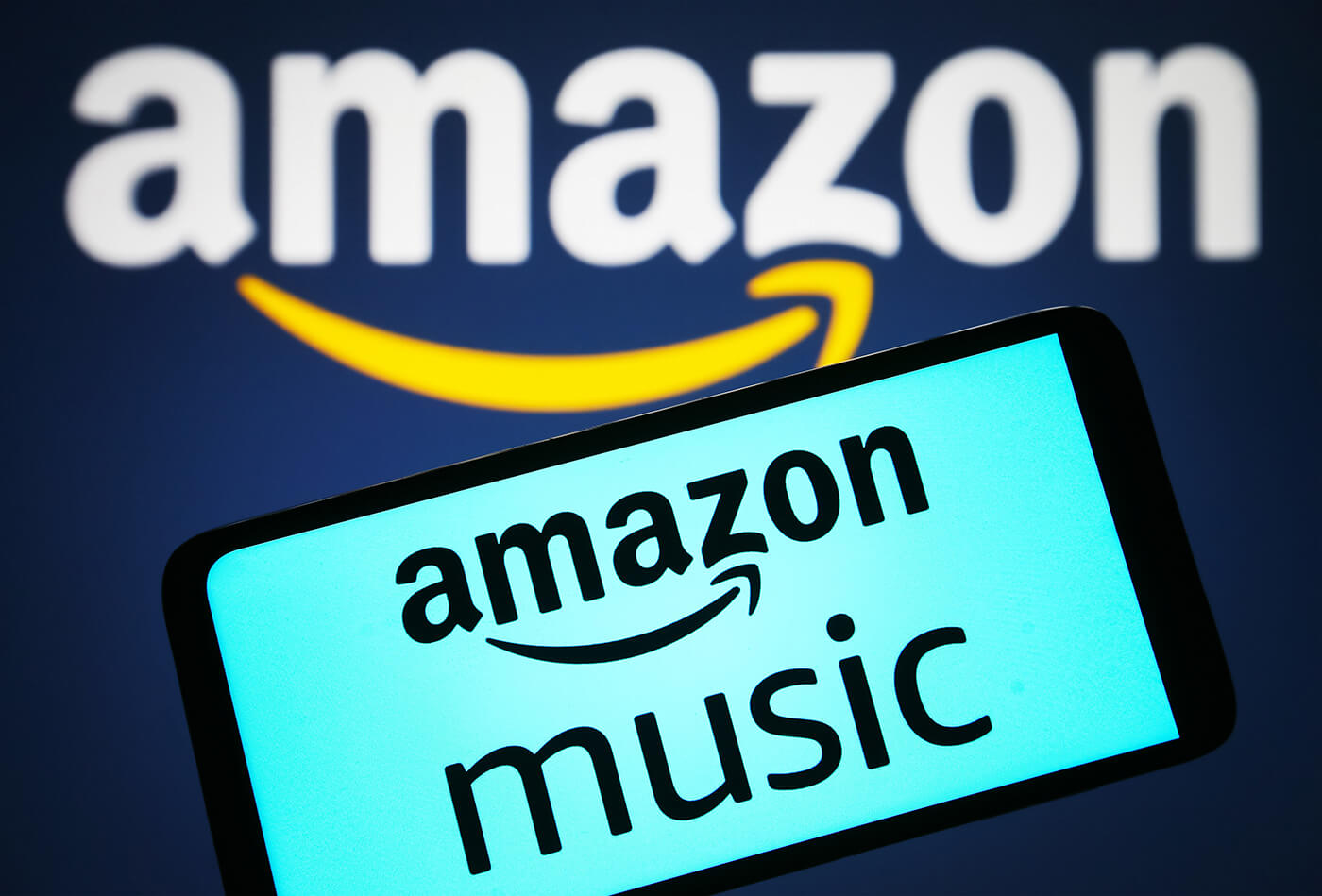 Amazon Music logo on a phone with the Amazon logo in the background, photo by Pavlo Gonchar/SOPA Images/LightRocket via Getty Images