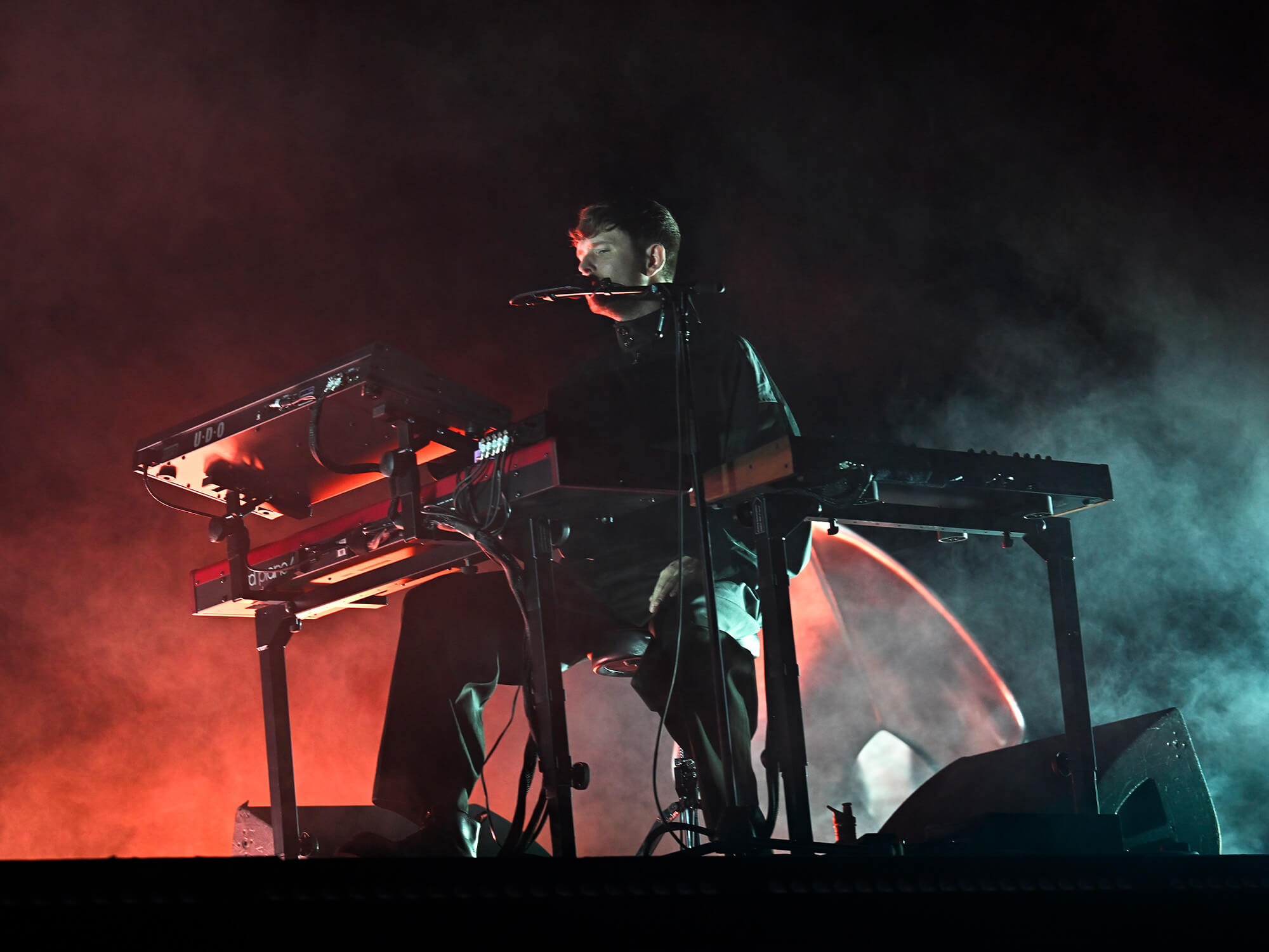 James Blake playing a keyboard on stage