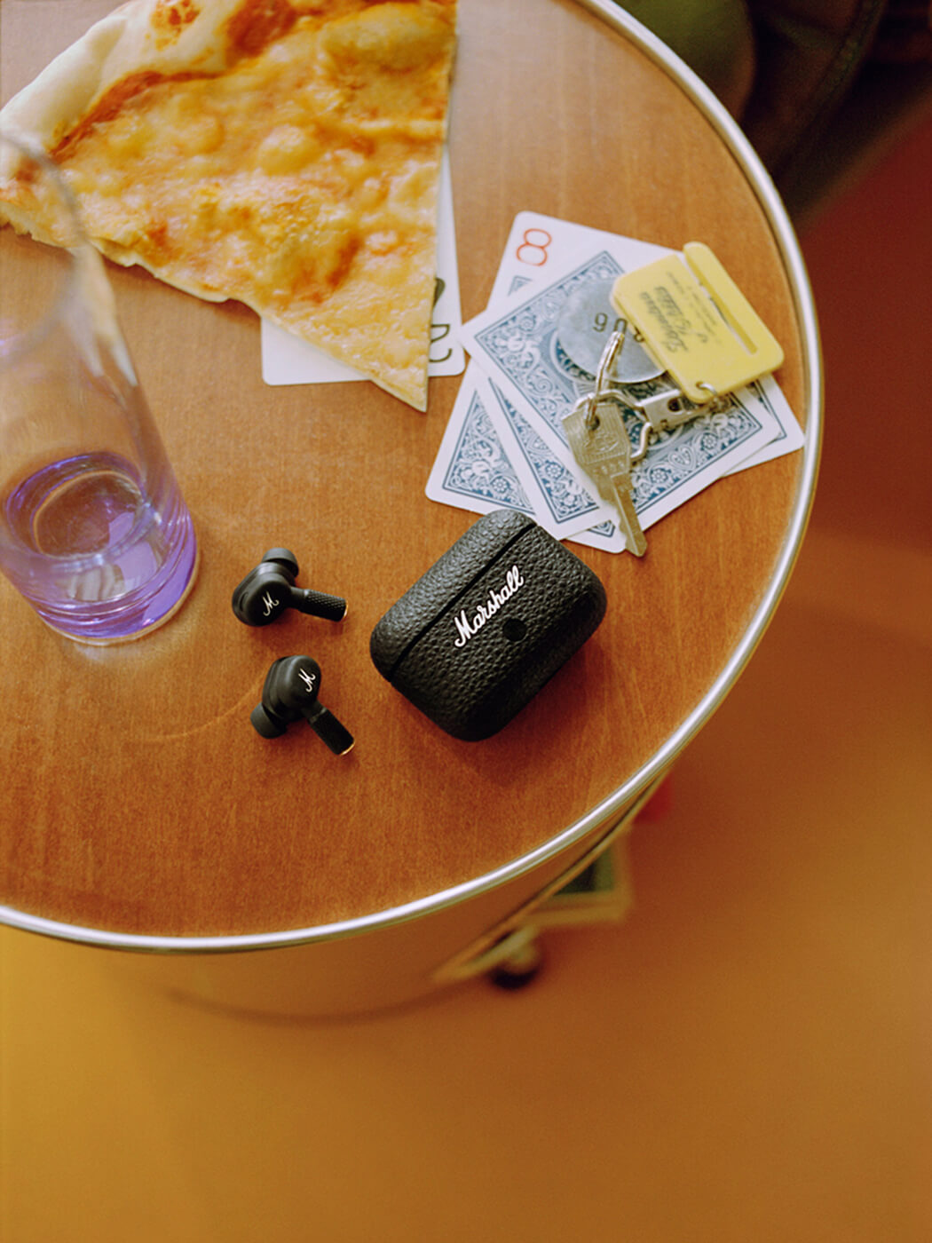 The Motif II ANC earbuds and their case on a coffee table, photo by Kevin Castanheira