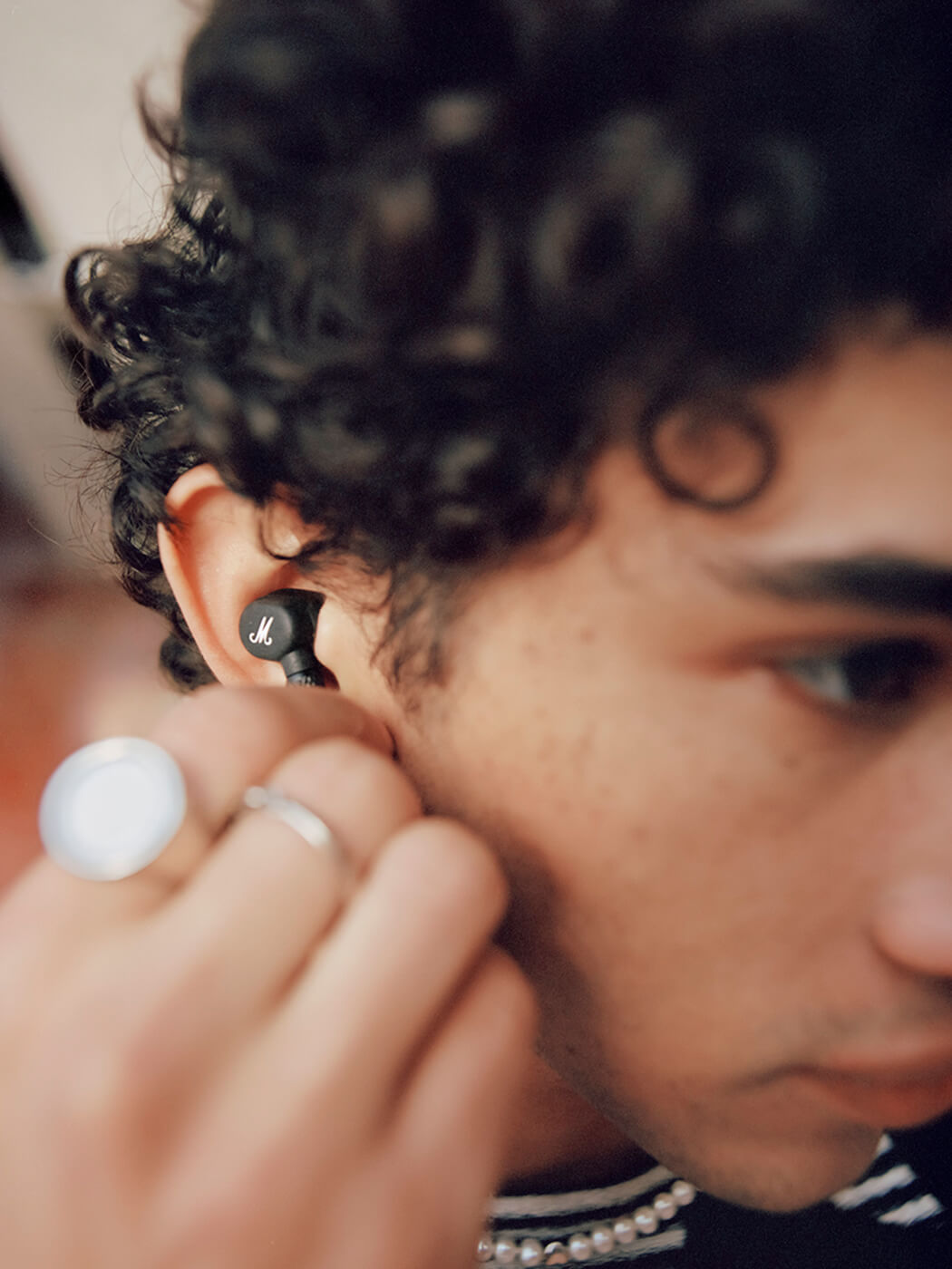 The Motif II ANC earbuds in use
