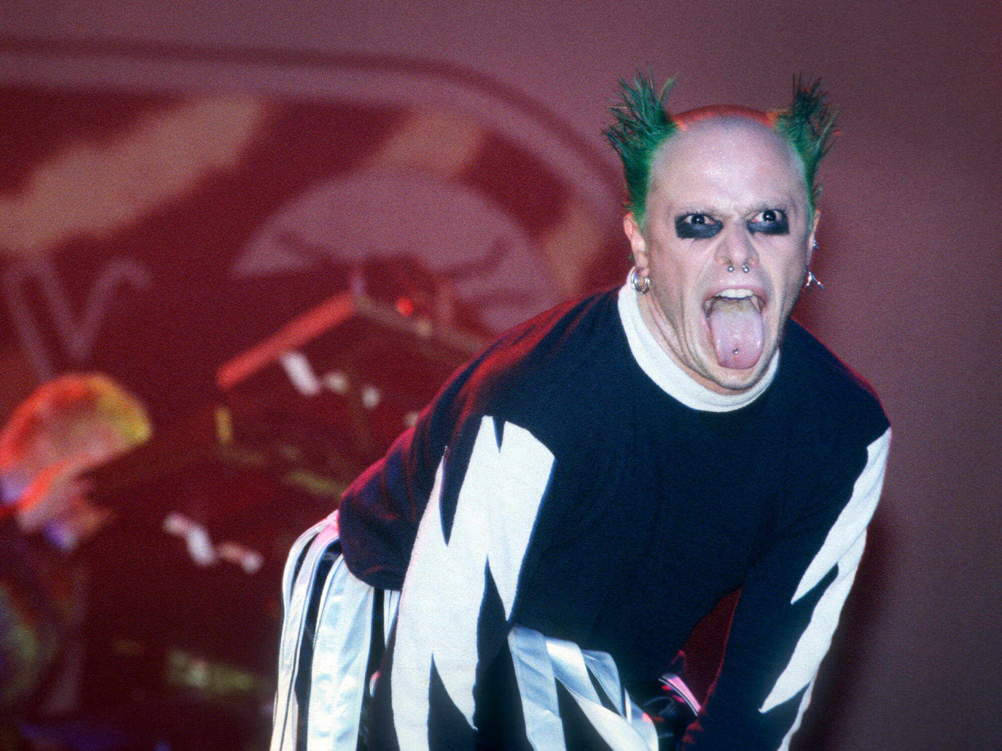 Keith Flint of The Prodigy. He is captured on stage sticking his tongue out